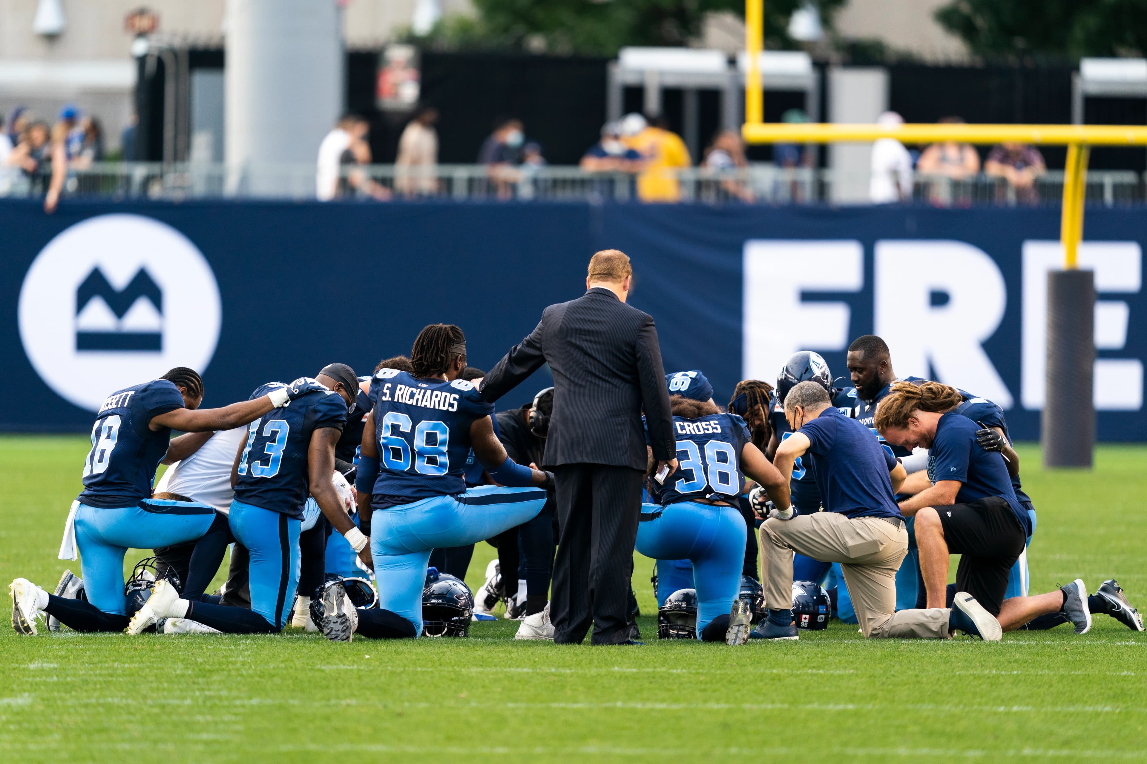 Declan and team praying after a game